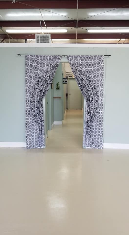 A hallway in a building with a curtain hanging on the wall.