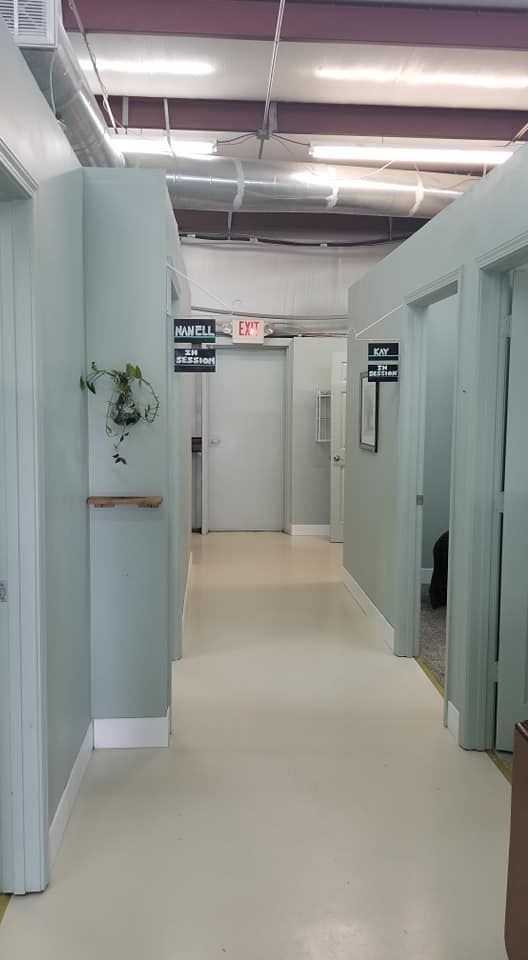 A long hallway with a lot of doors in a hospital.