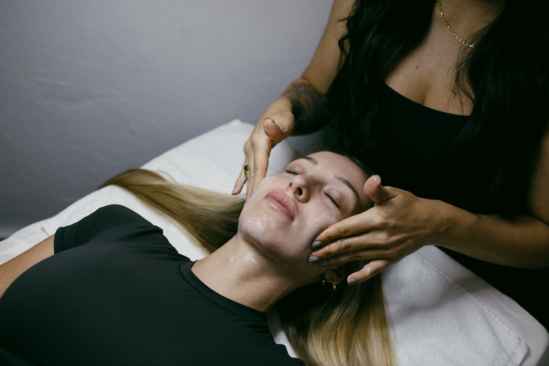 A woman is getting a massage on her face in a spa.