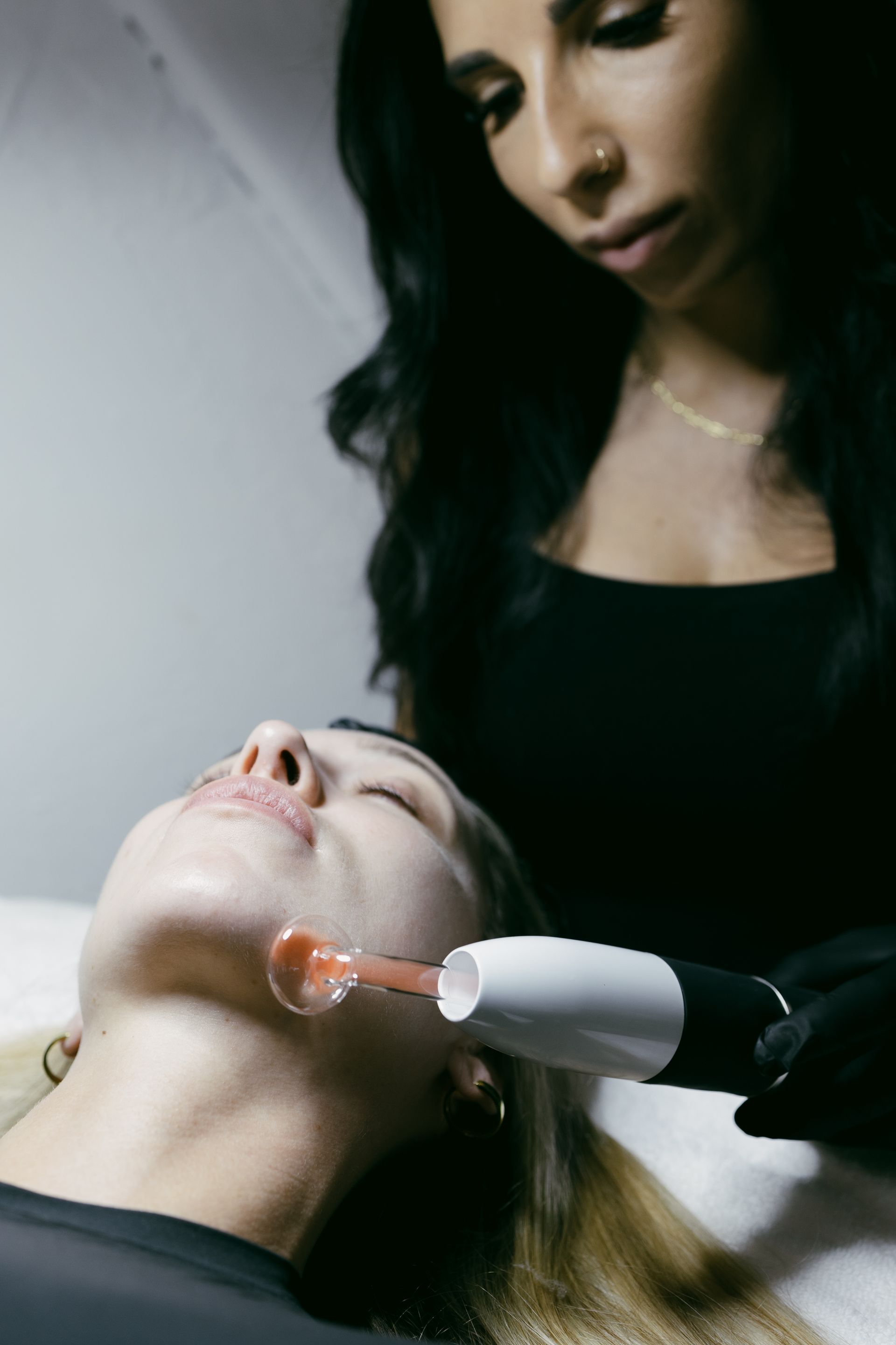 A woman is getting a facial treatment at a skincare studio.