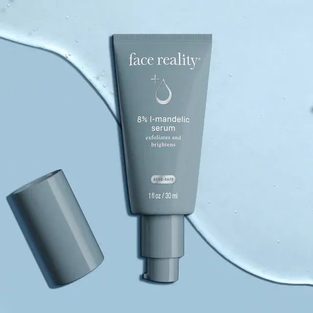 A tube of face reality serum is sitting on a blue surface