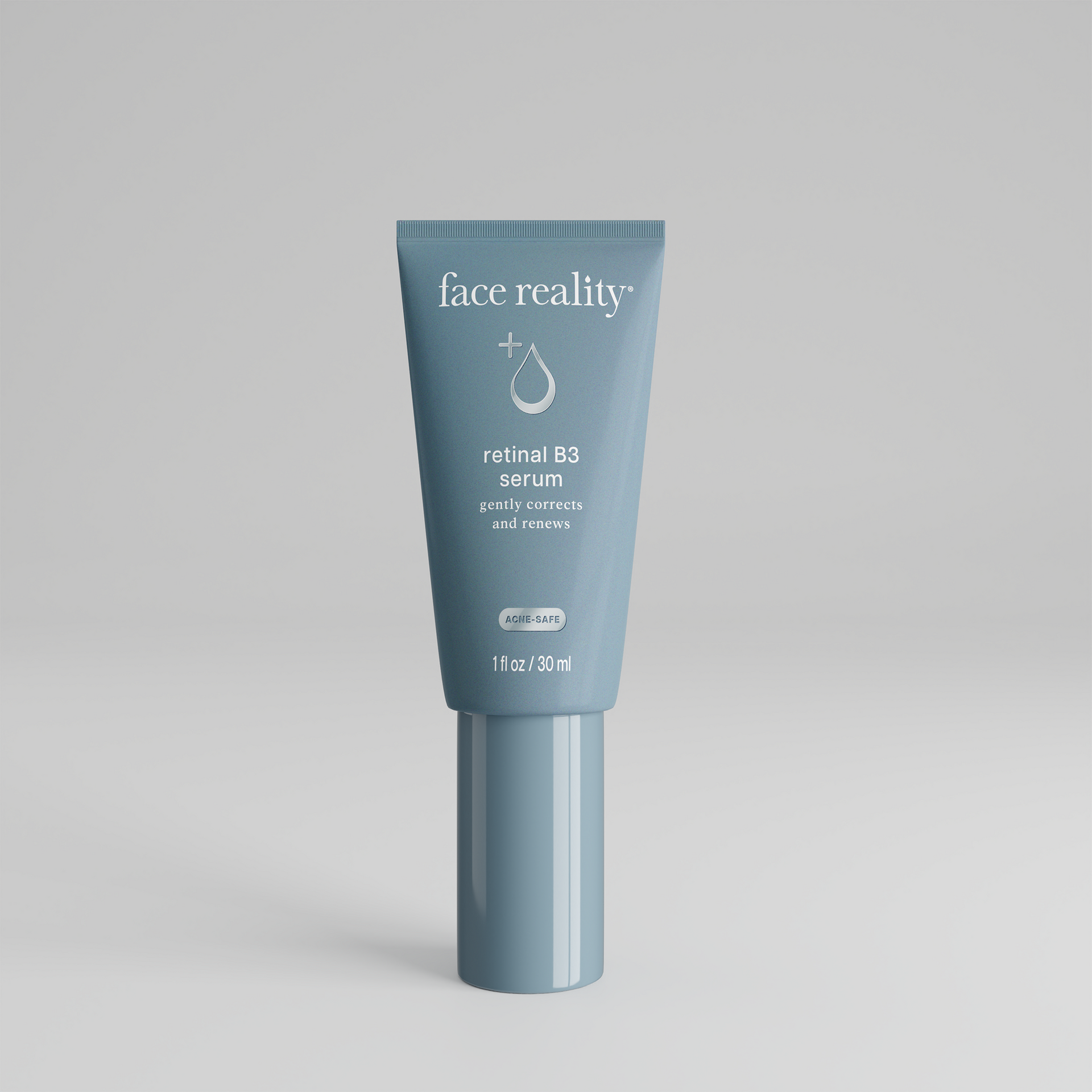 A blue tube of face reality serum is sitting on a white surface.