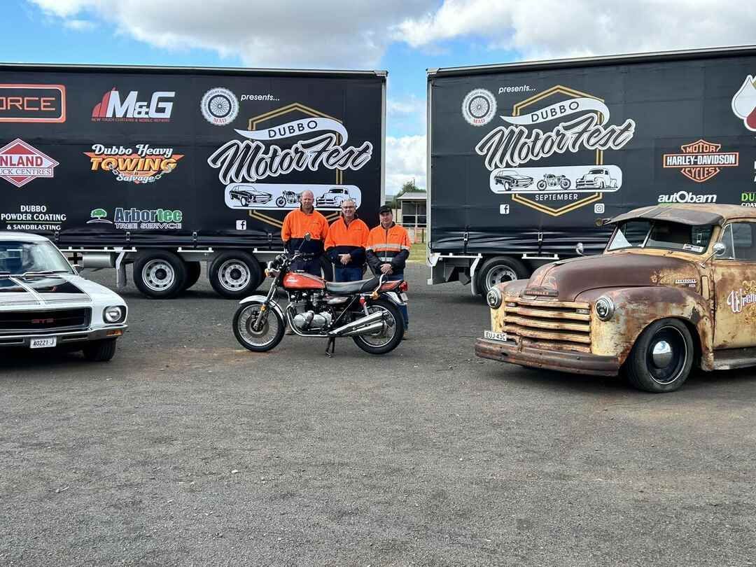 Group of People Standing Next to a Motorcycle and a Truck in a Parking Lot — Transforce in Orange, NSW
