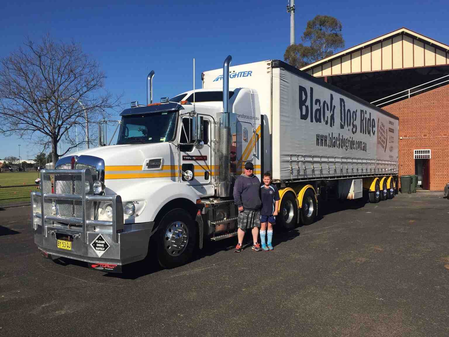 Two People Are Standing in Front of a Truck That Says Black Dog Vice — Transforce in Orange, NSW