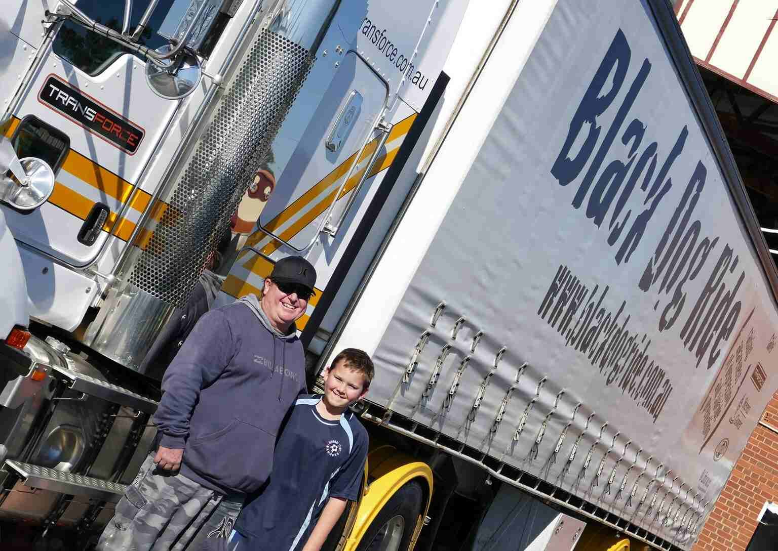 Man and a Boy Standing in Front of a Truck That Says Black Dog Rides — Transforce in Wellington, NSW