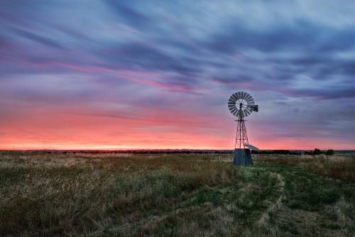 Windmill is Sitting in the Middle of a Field at Sunset — Transforce in Orange, NSW