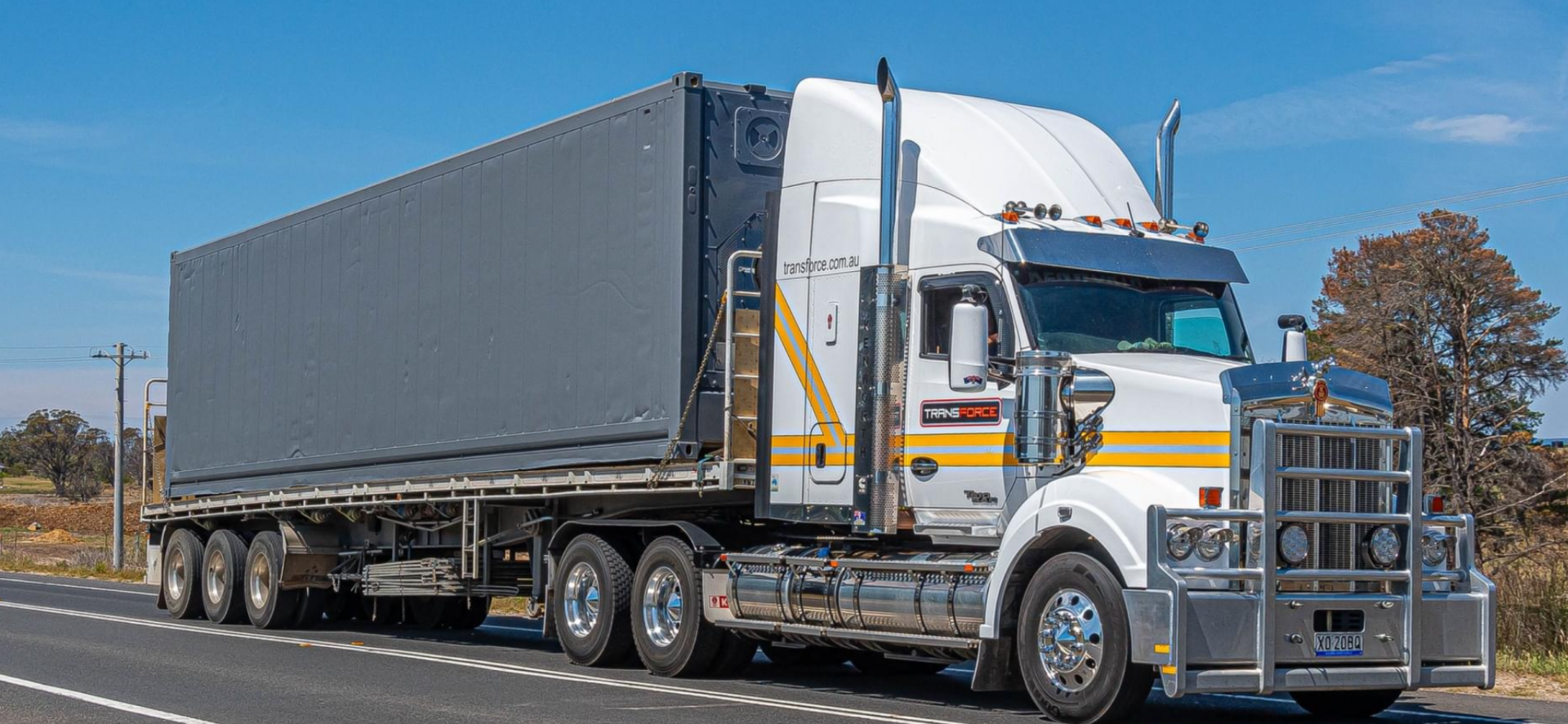Truck is Driving Down a Highway With a Blue Tarp on the Back of It — Transforce in Dubbo, NSW