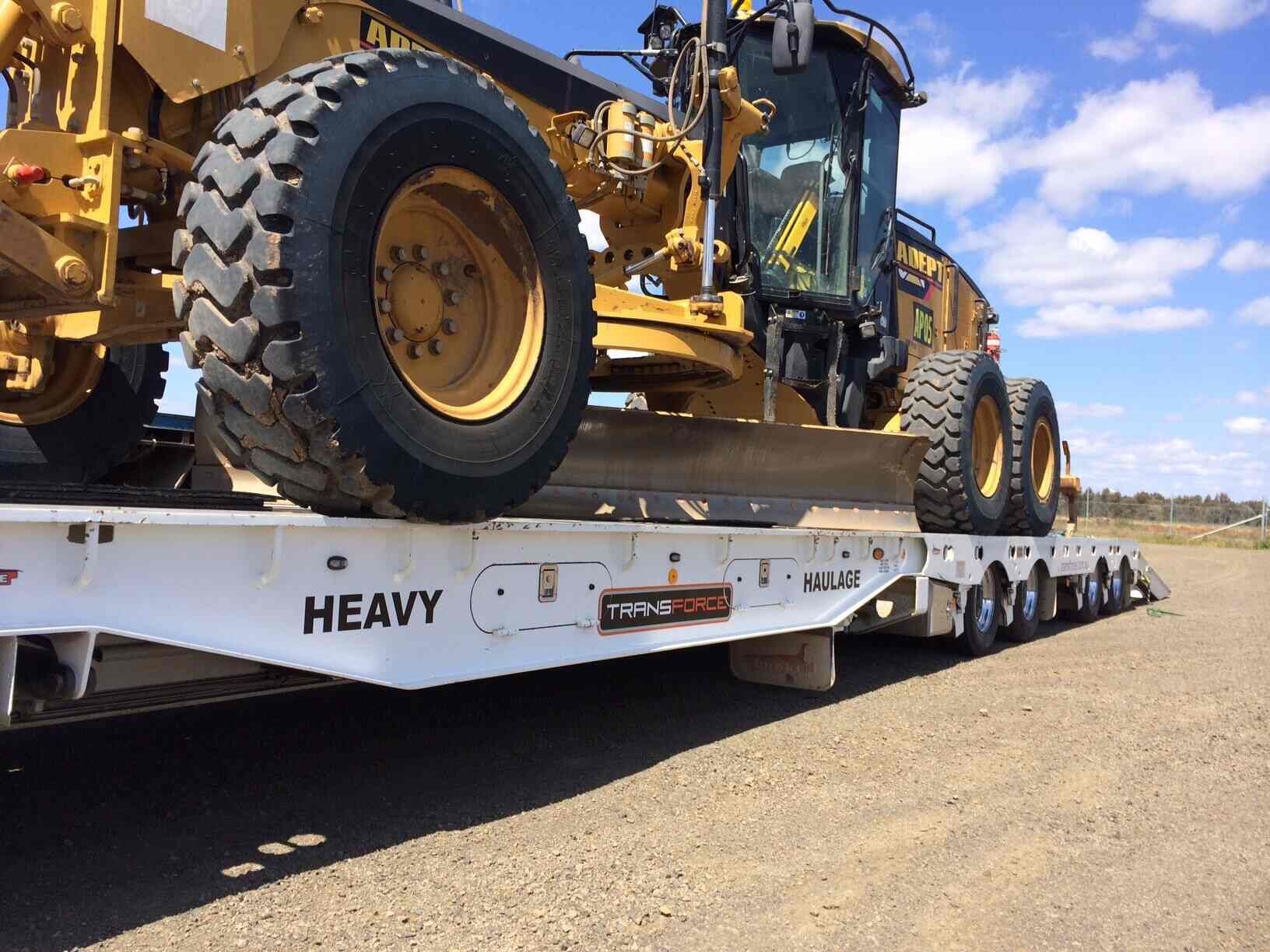 Heavy Machinery is Being Transported on a Flatbed Trailer — Transforce in Dubbo, NSW