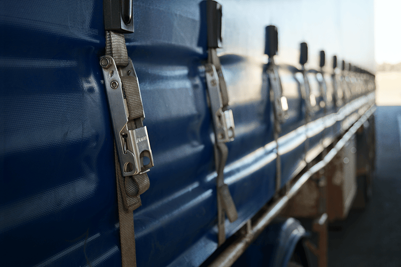 Close Up of a Blue Truck With Straps Attached to It — Transforce in Dubbo, NSW