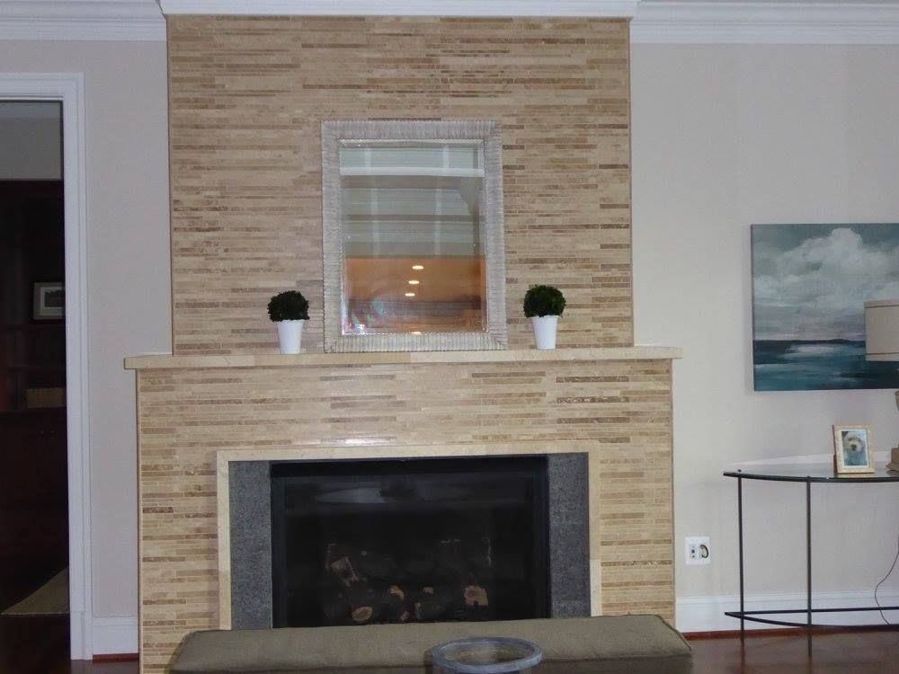 A living room with a fireplace and a mirror