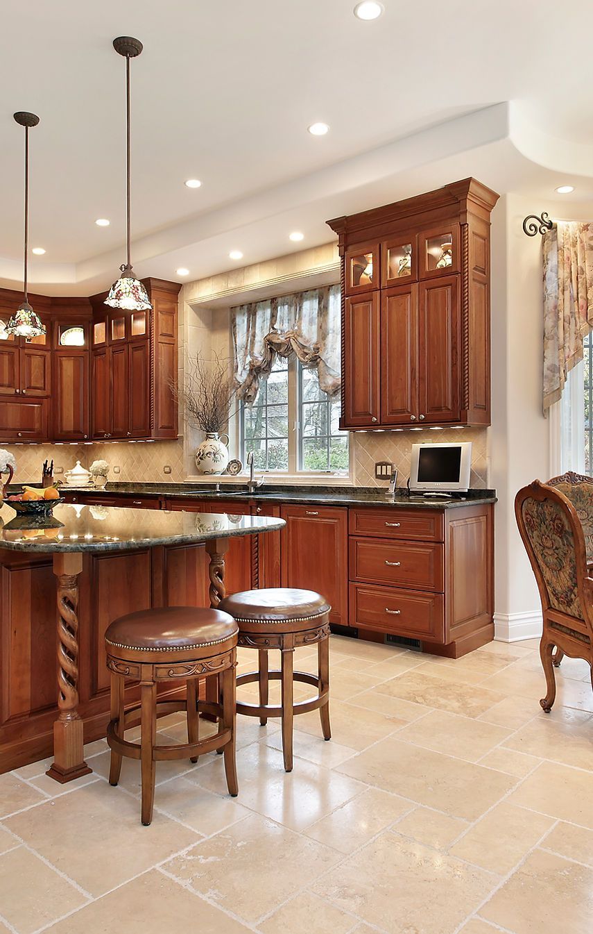 A kitchen with wooden cabinets and granite counter tops