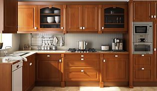 A kitchen with wooden cabinets and stainless steel appliances.
