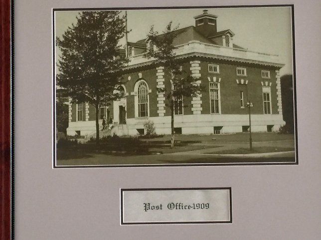 Historic sepia-toned photograph of a brick Post Office building from 1909.