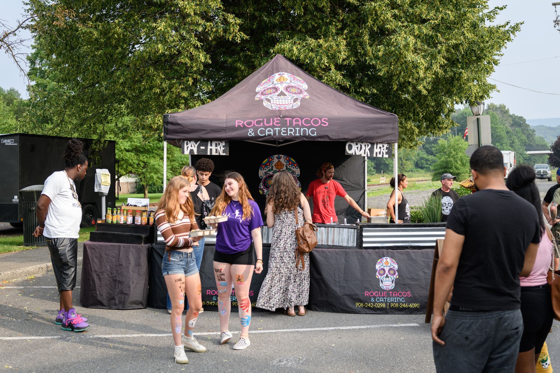 A group of people are standing in front of a tent.