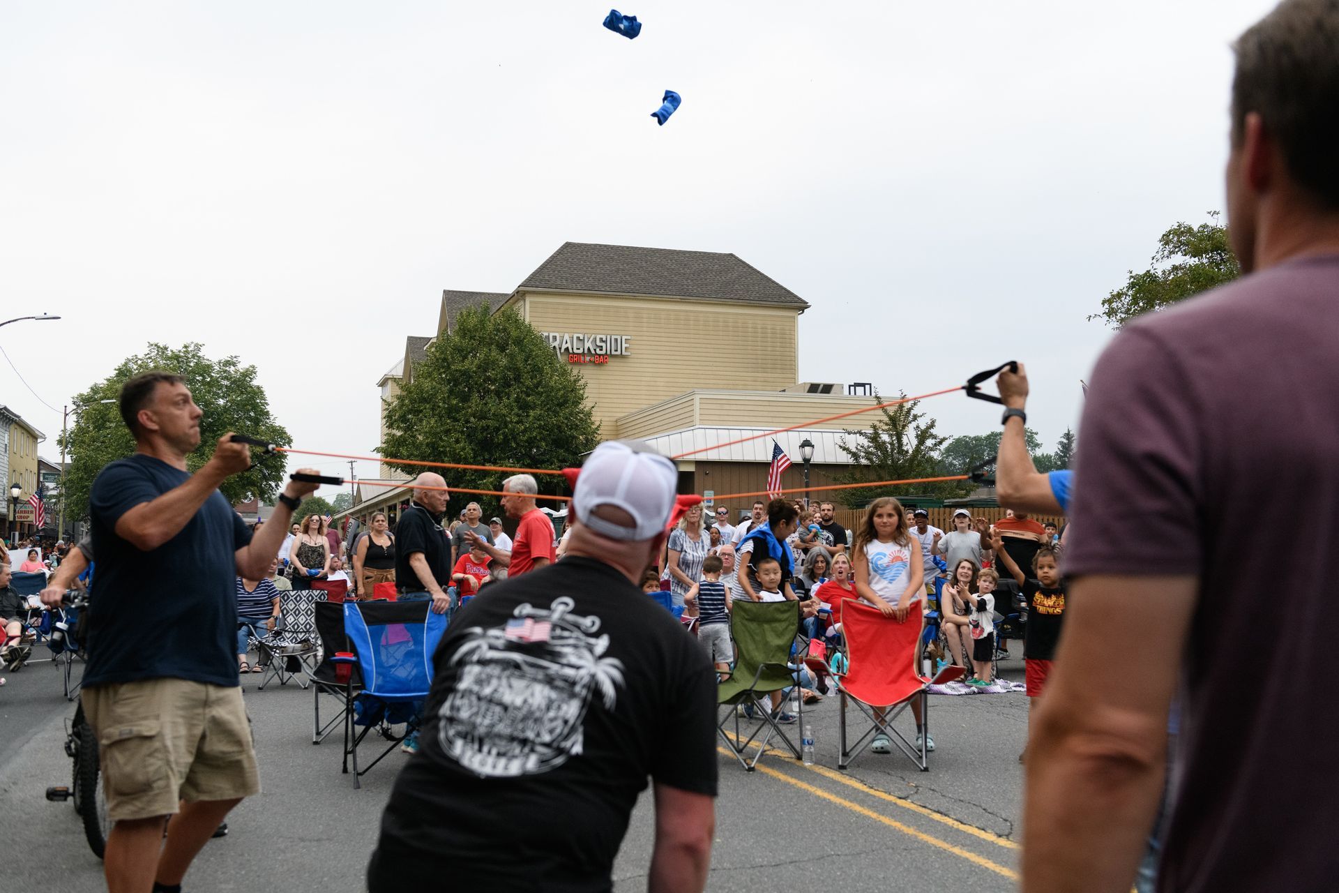 A man in a black shirt is throwing a frisbee in the air.