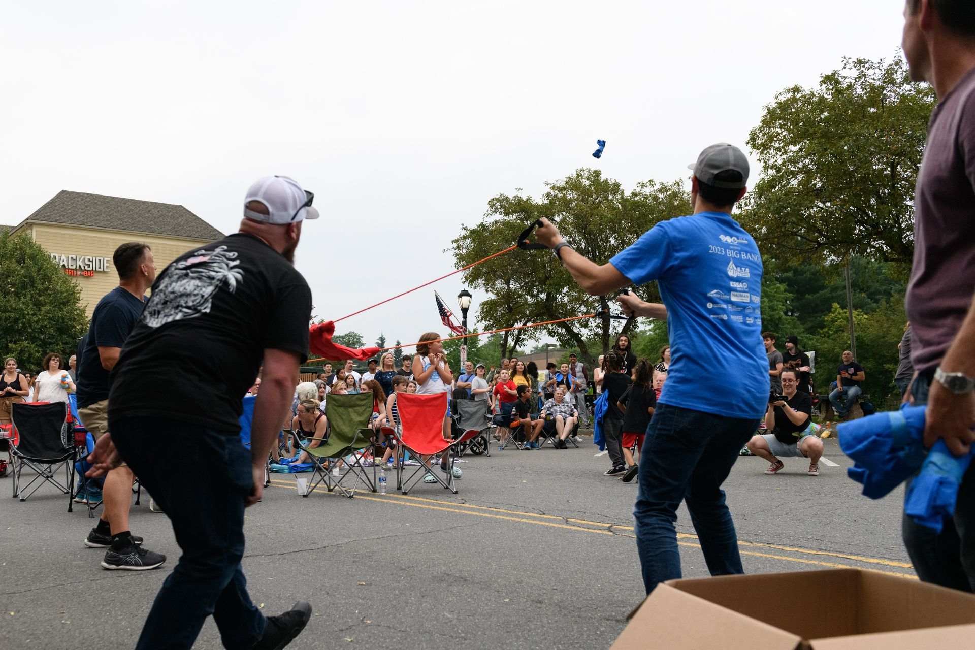 A group of people are playing a game on the street.