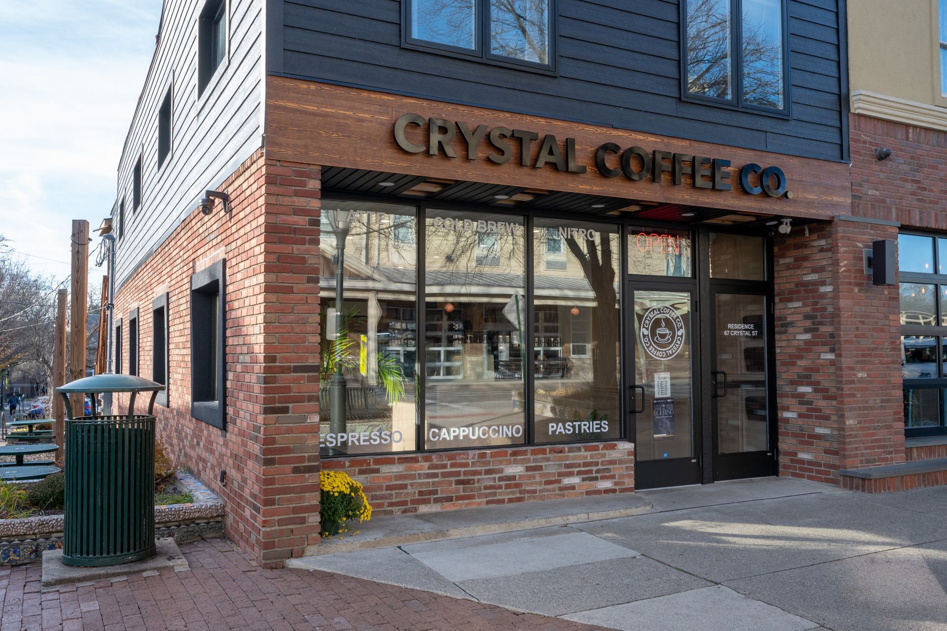 Crystal Coffee Co. storefront, brick and black exterior with large windows, sign above.