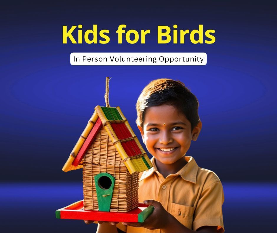 A young girl is holding a potted plant in front of a sign that says kitchen garden