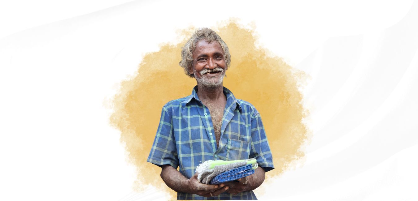 A man with a beard is holding a corn on the cob in his hands.