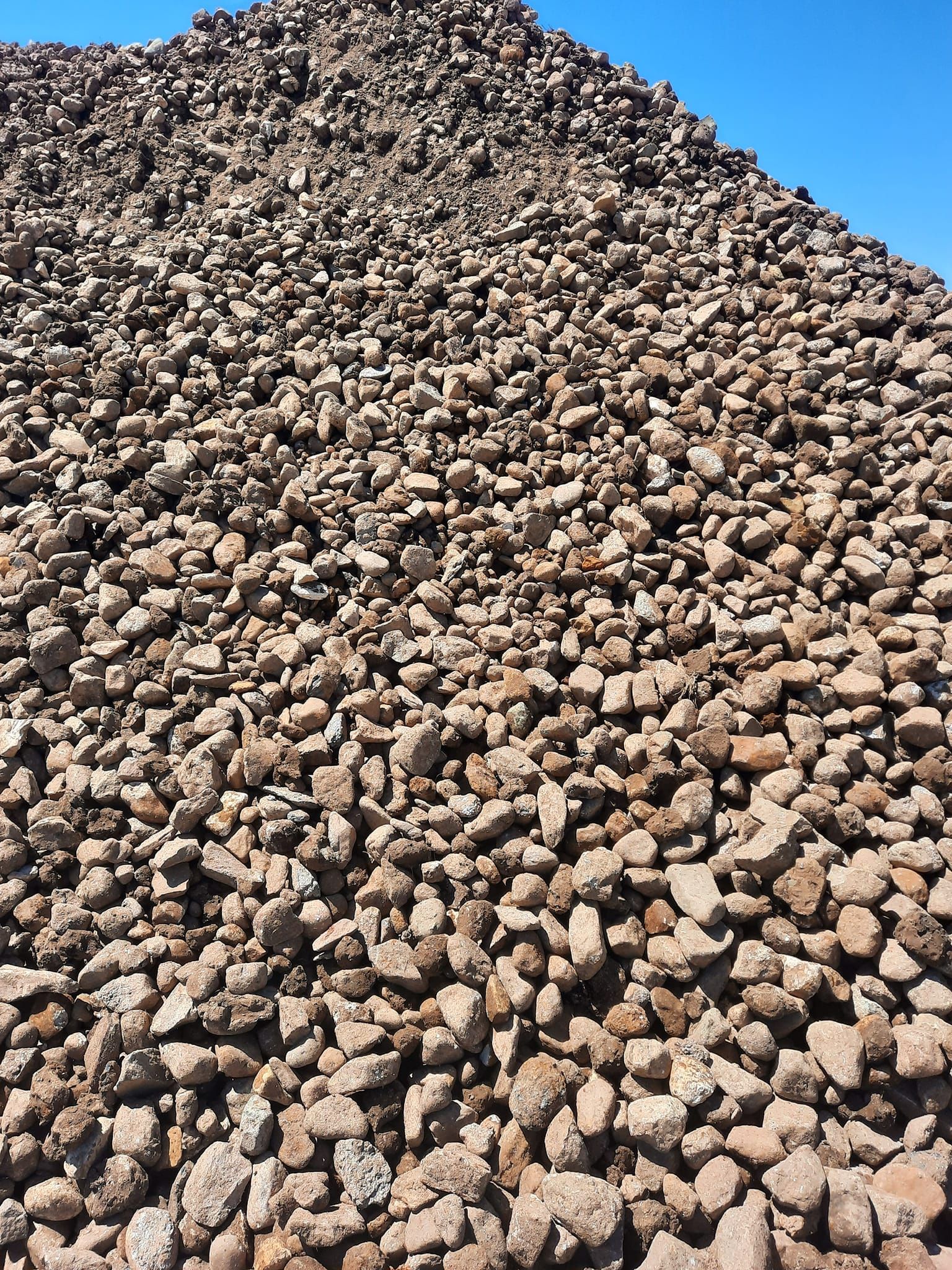 A large pile of rocks is sitting on top of a hill.