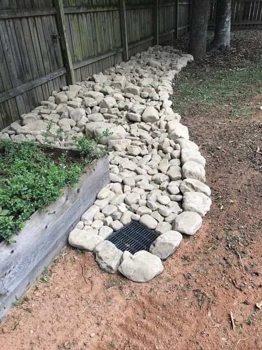 A path made of rocks next to a wooden fence.