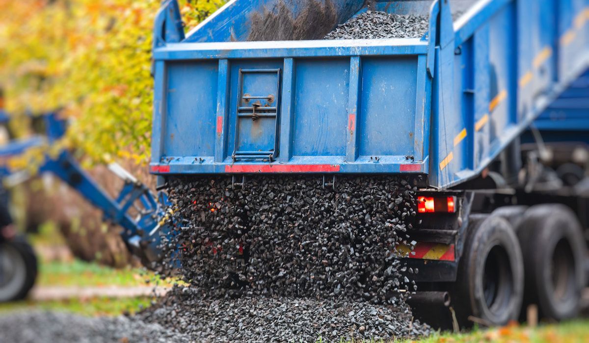 A conveyor belt is sitting on top of a pile of dirt.