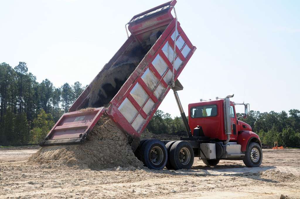 A conveyor belt is carrying a pile of rocks in a quarry.