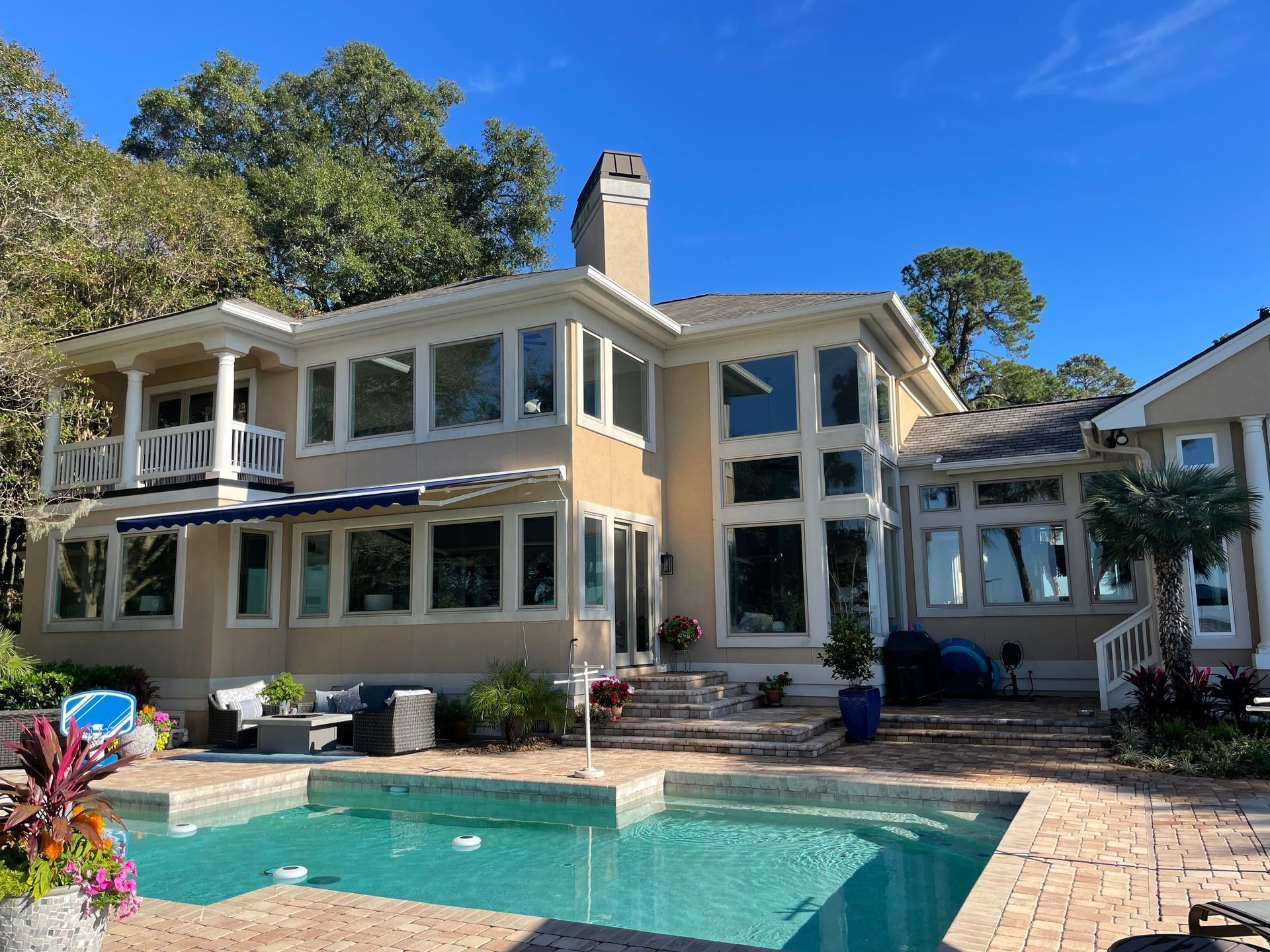 A large house with a swimming pool in front of it