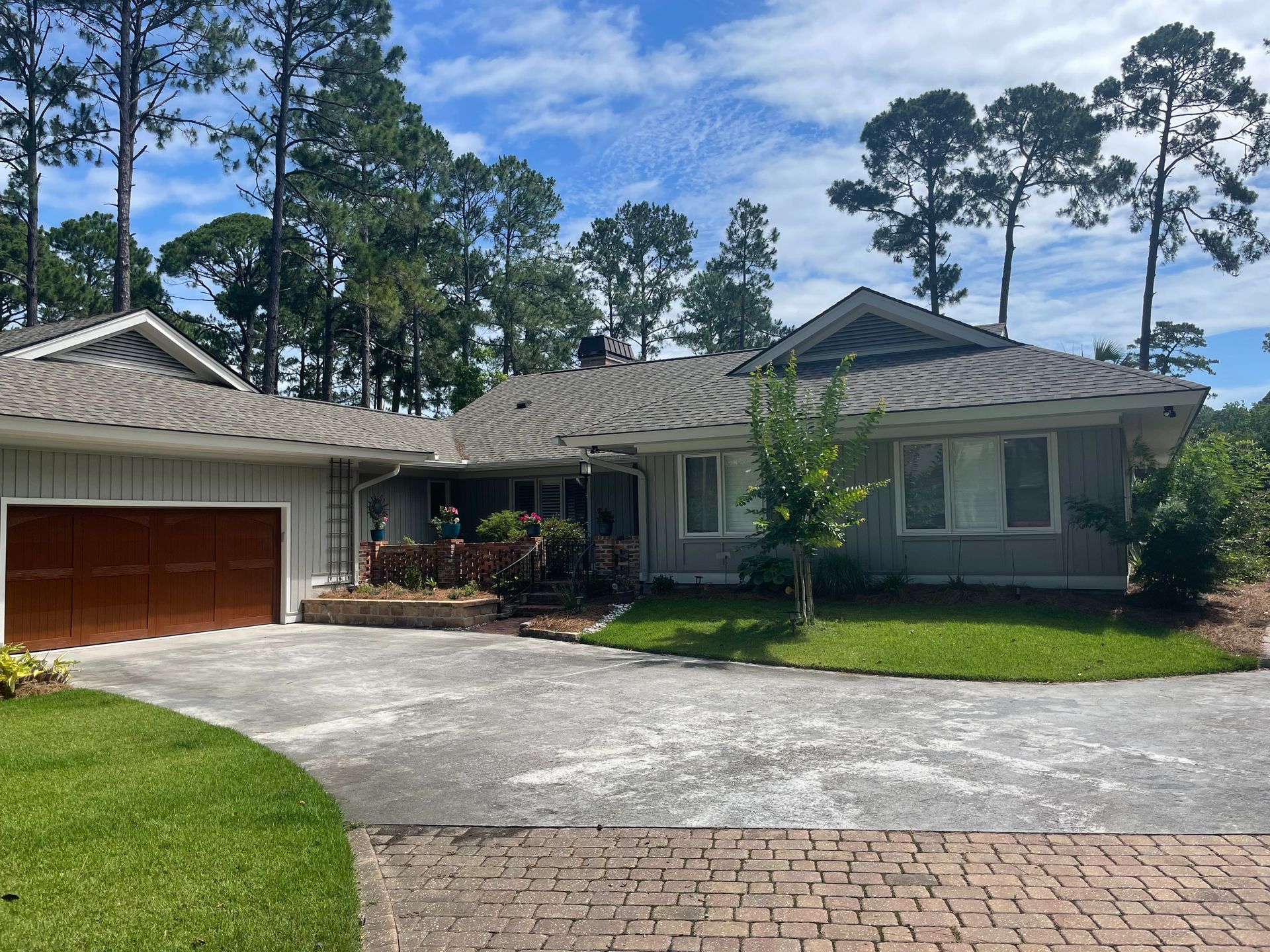 A house with a garage and a driveway in front of it
