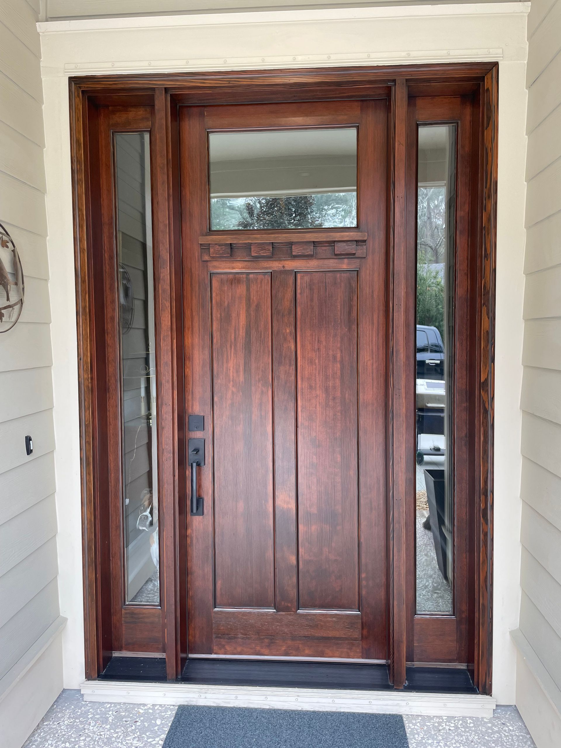 A large wooden door with a glass window