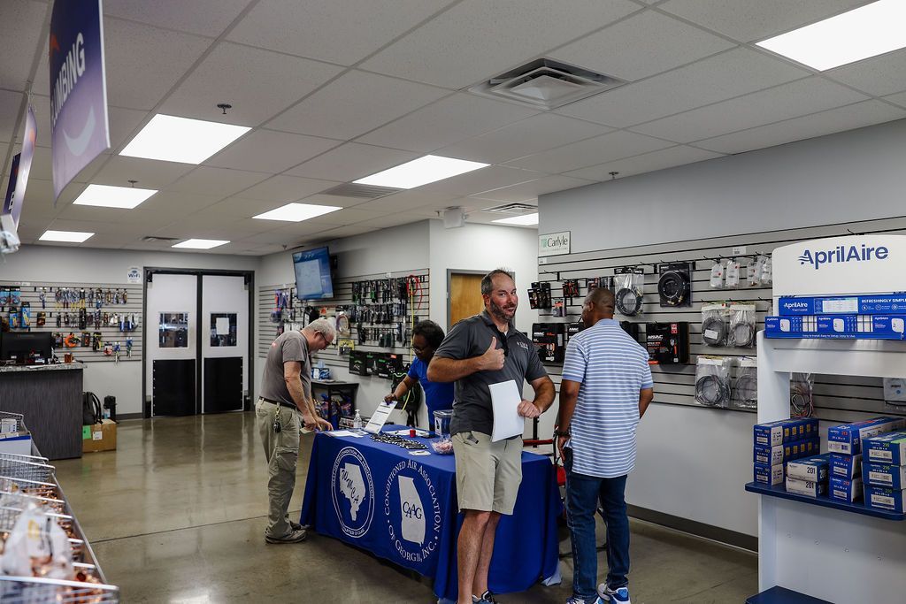 A group of men are standing around a table in a store.