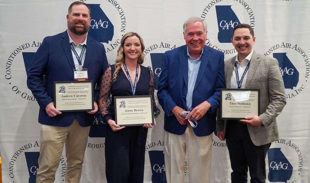 A group of people are standing next to each other holding certificates.