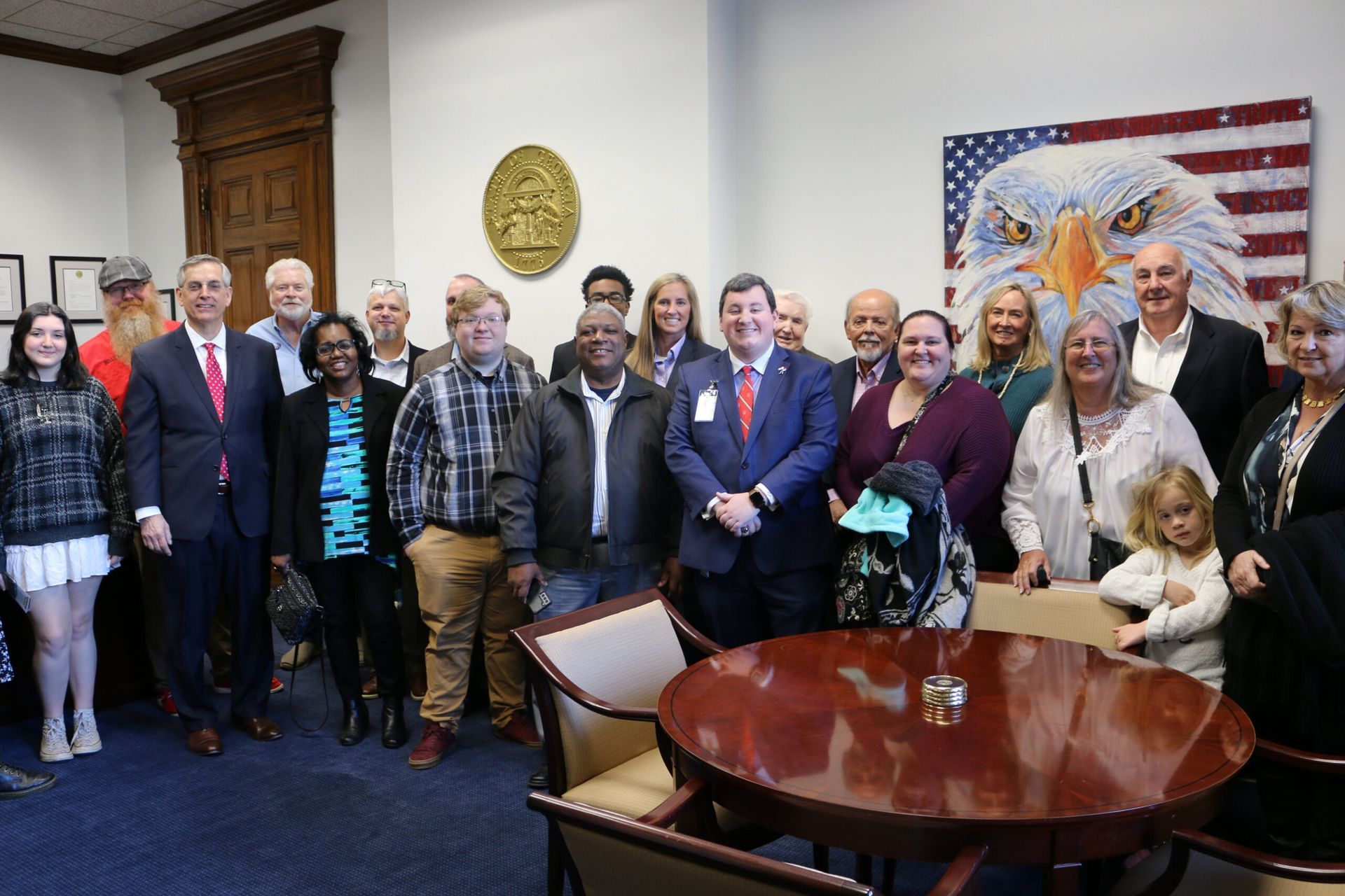 A group of people are posing for a picture in a room.