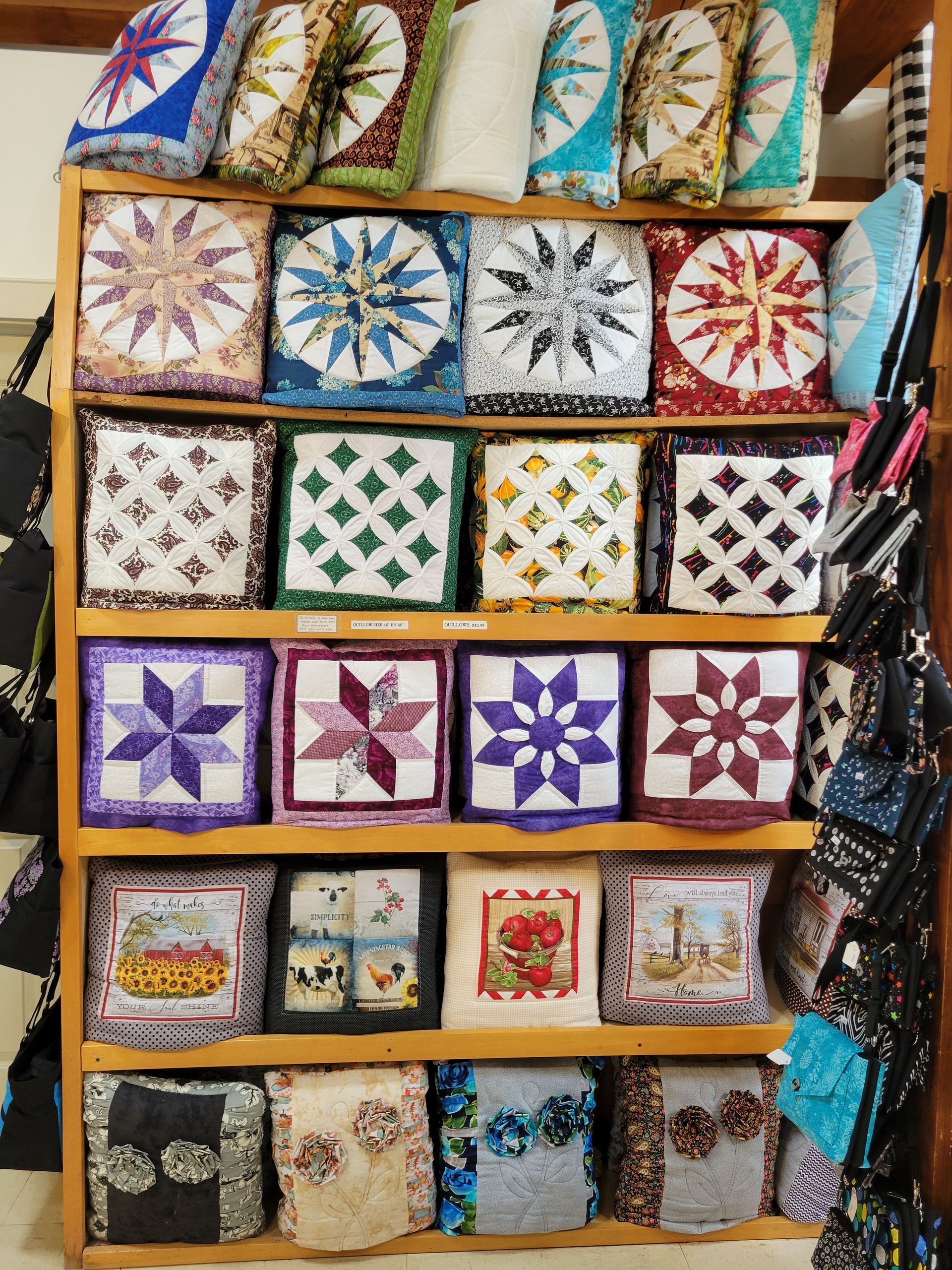 A shelf filled with lots of pillows with pictures on them