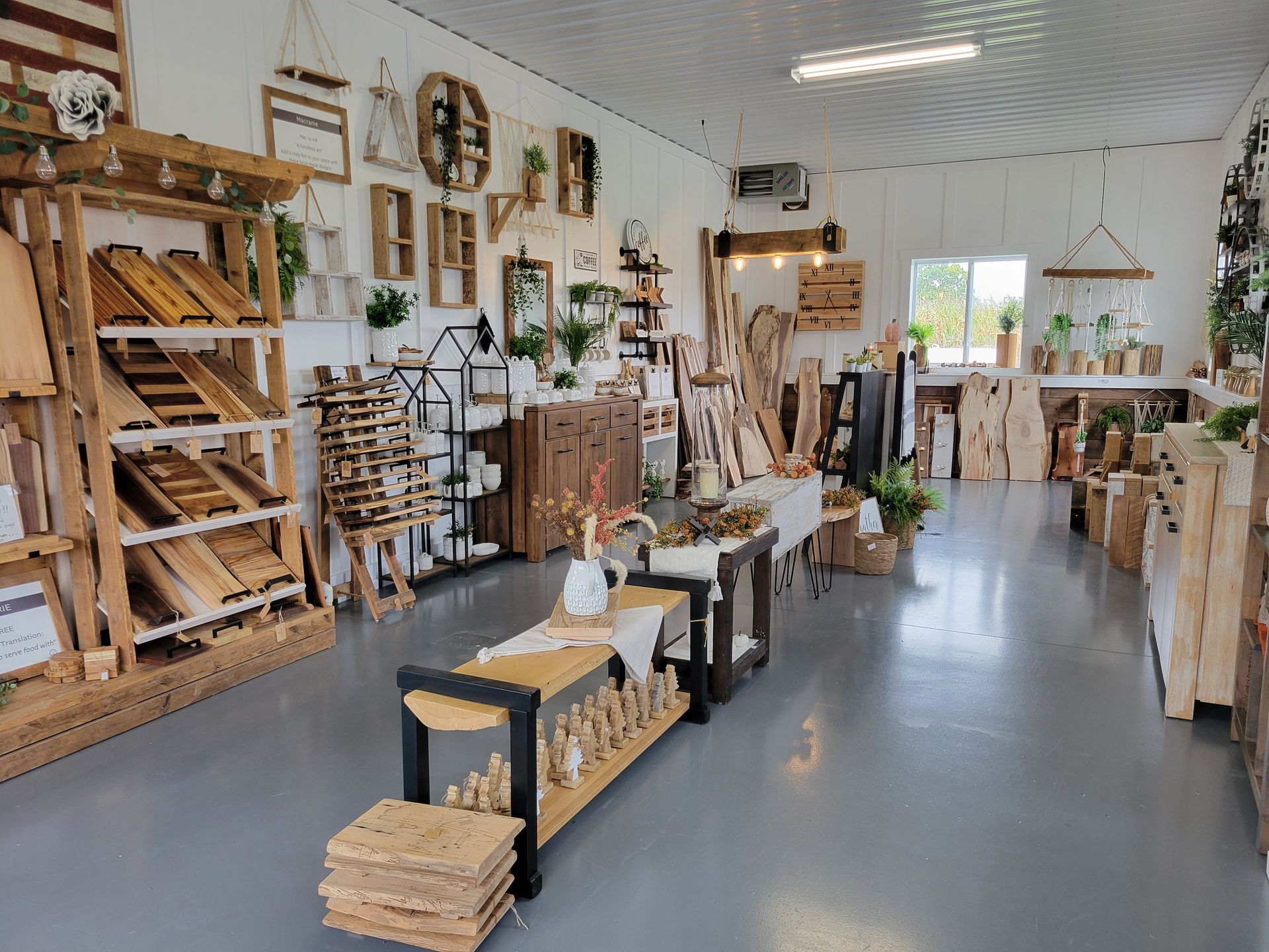 A shelf full of wicker baskets and a sign that says ' handmade ' on it