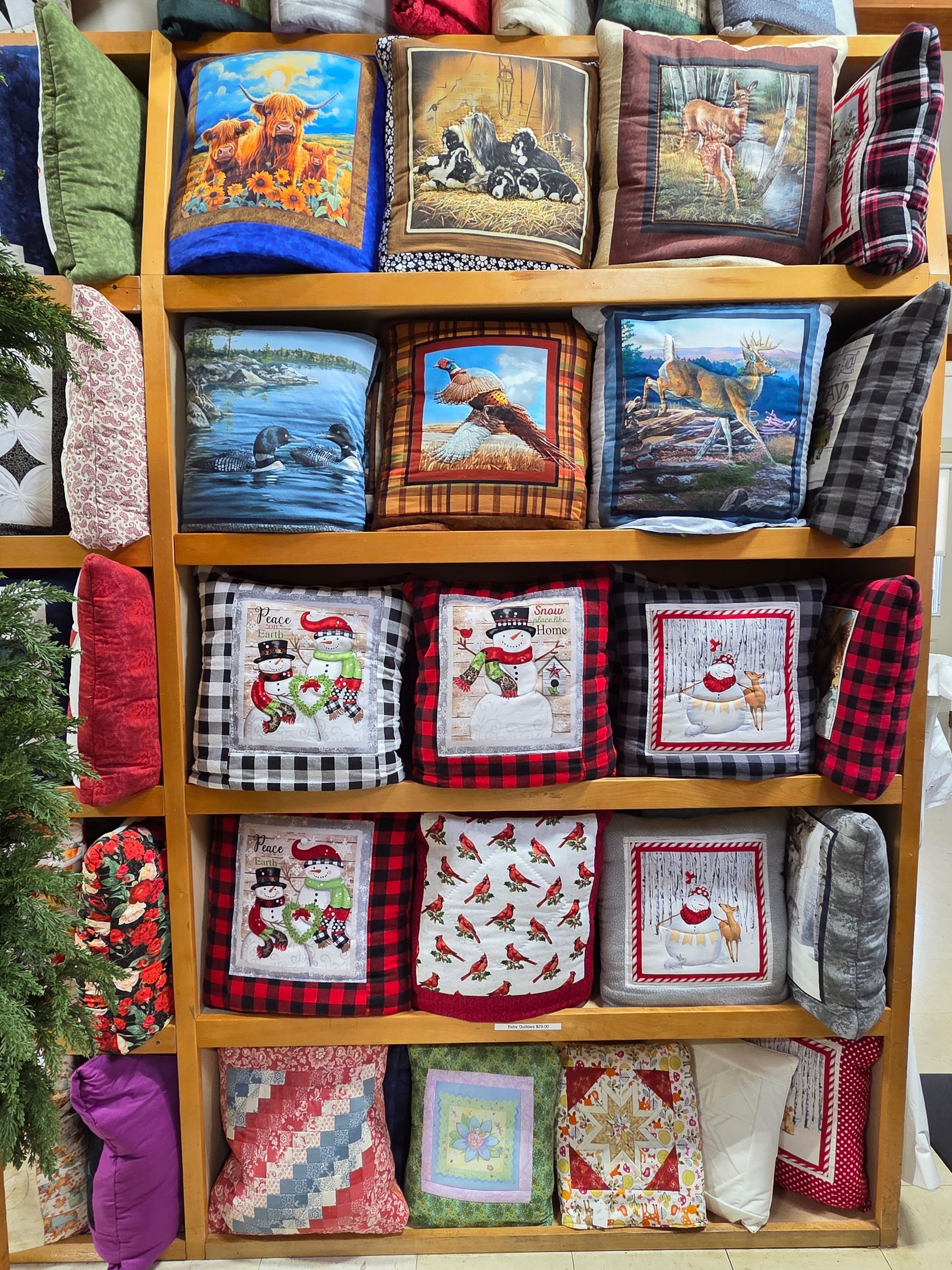 A shelf filled with lots of pillows with pictures on them