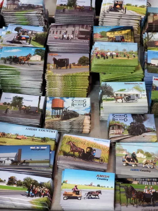 A bunch of postcards are stacked on top of each other