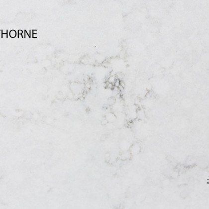 A close up of a white marble counter top.