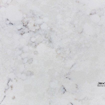 A close up of a white marble counter top.