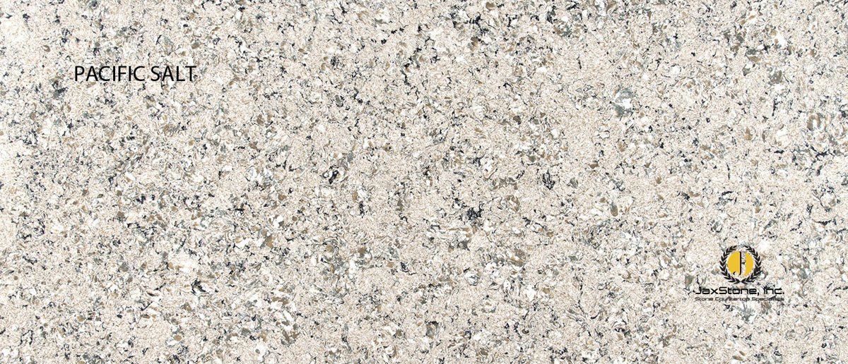 A close up of a white granite counter top.