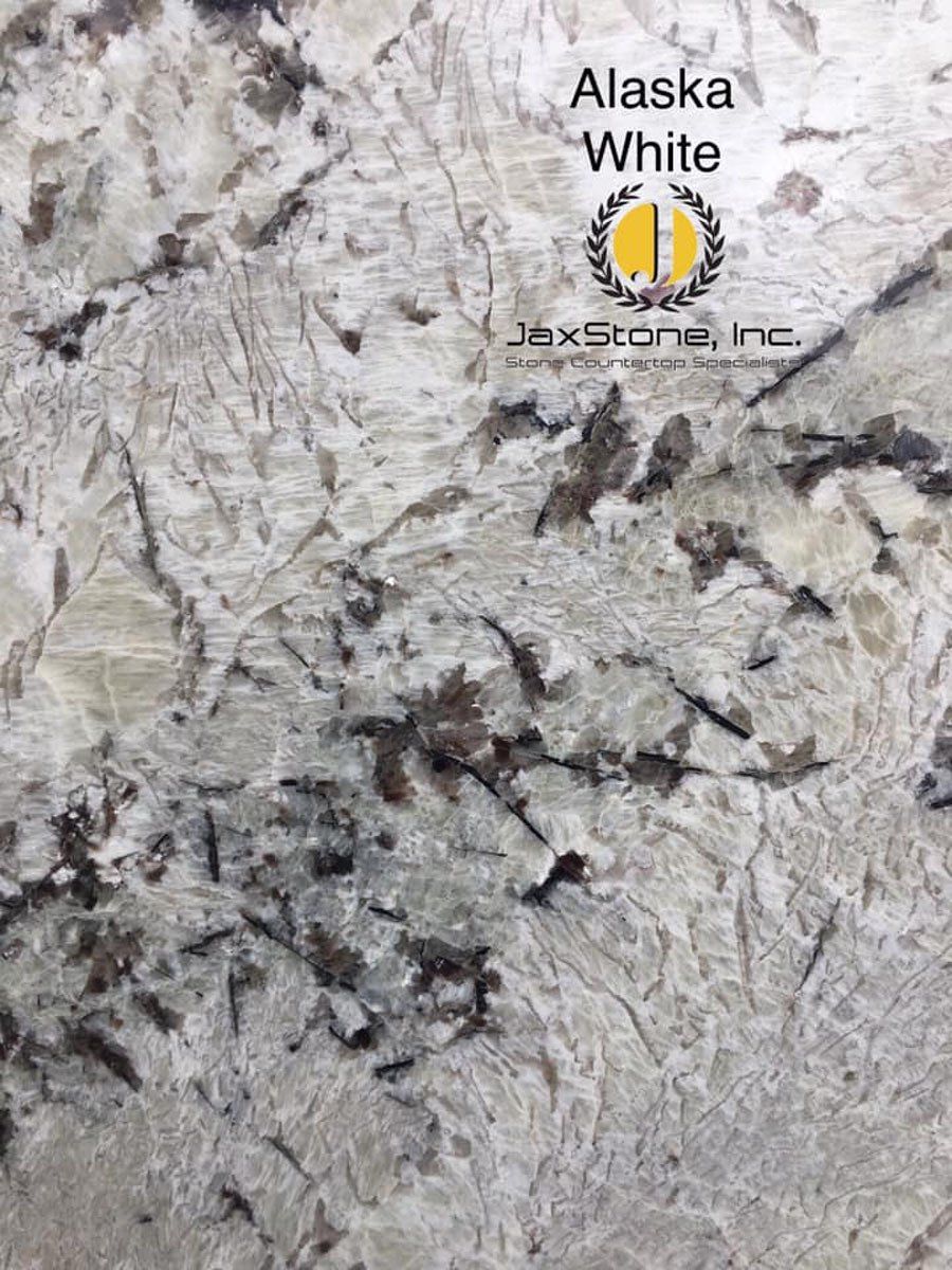 A close up of a slab of alaska white granite.