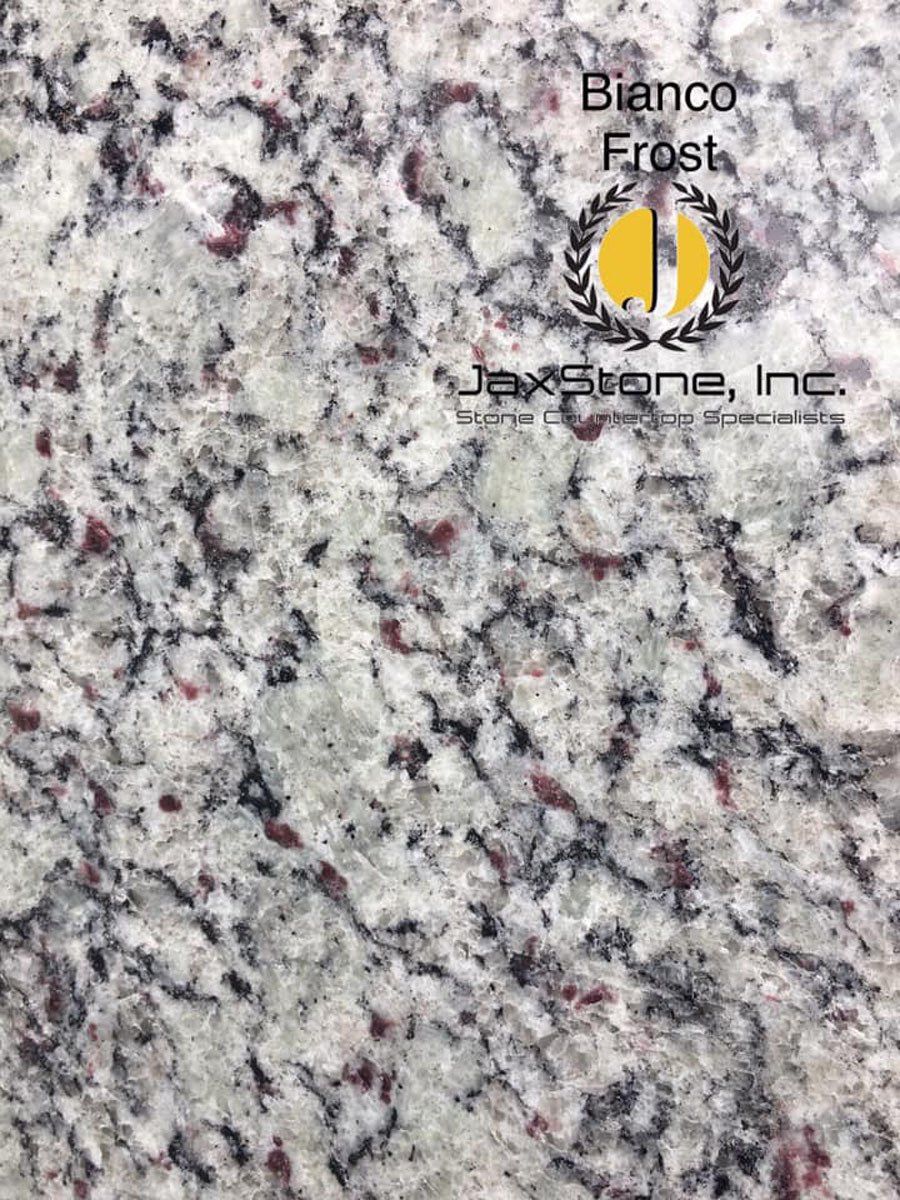 A close up of a white granite counter top.