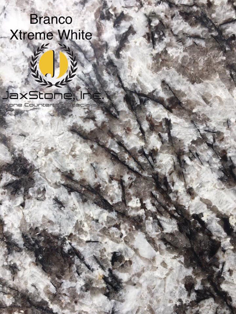 A close up of a white granite counter top.