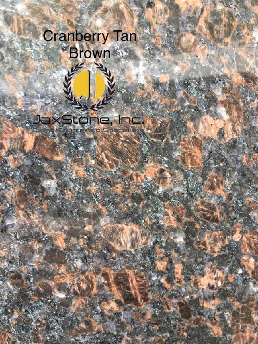 A close up of a cranberry tan brown granite slab.