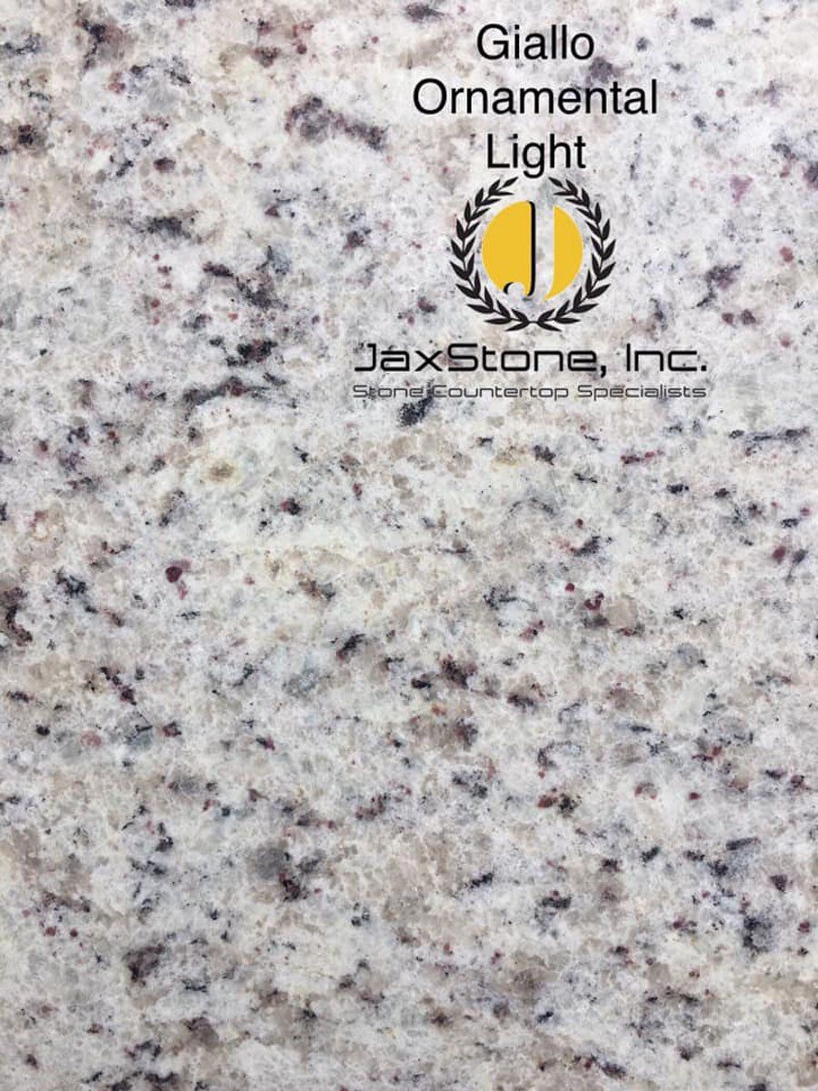 A close up of a granite counter top that says giallo ornamental light
