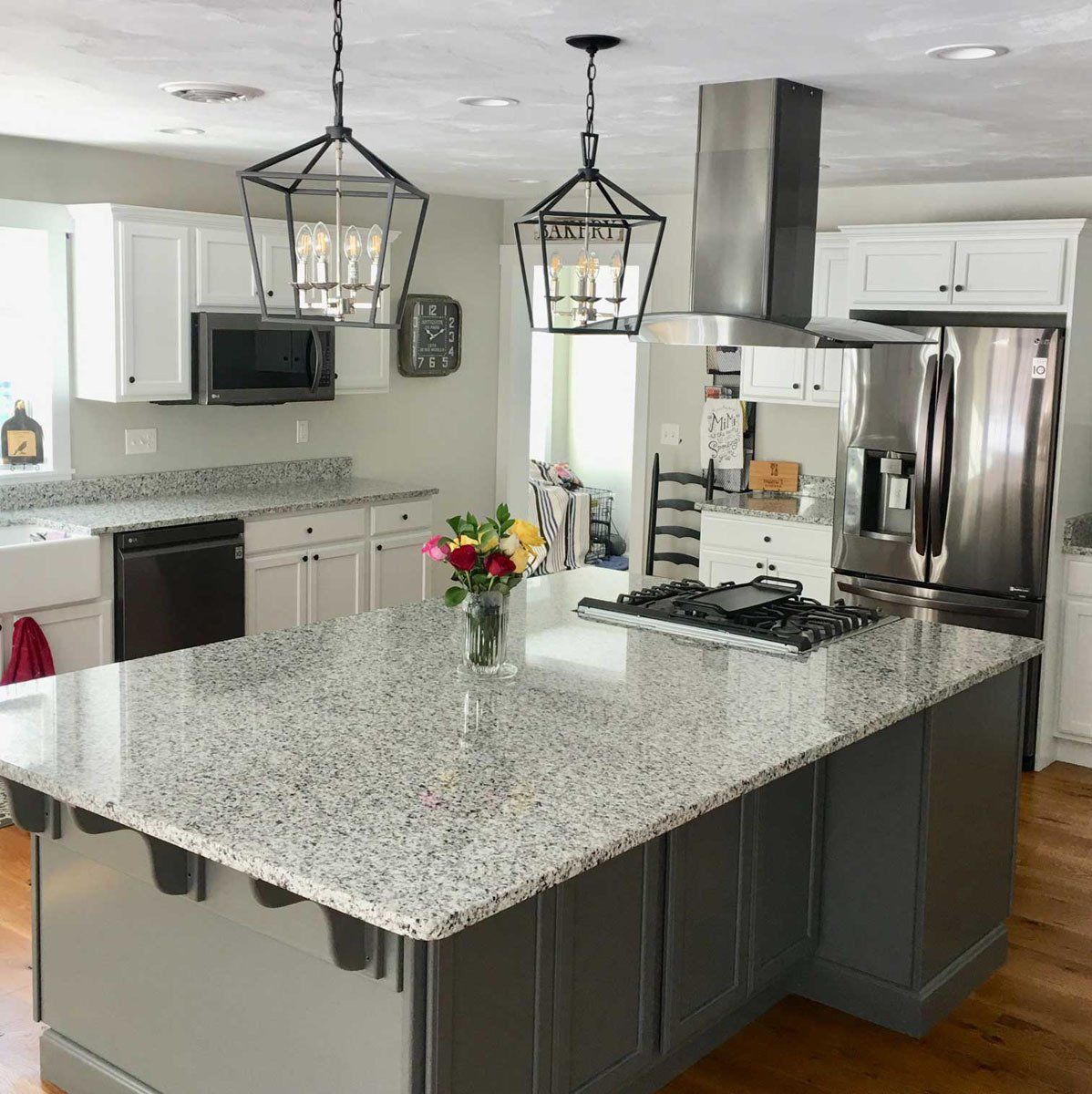 A kitchen with a large island and granite counter tops