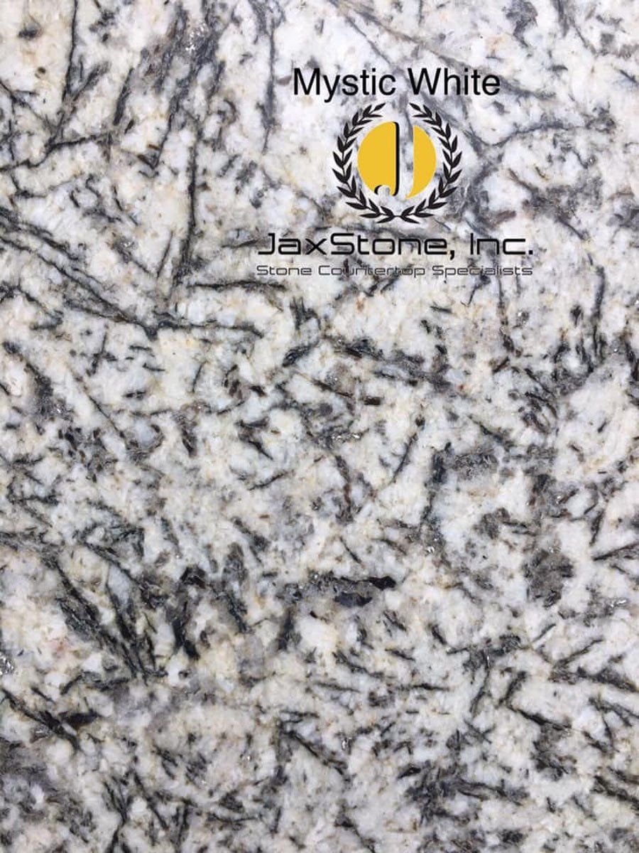 A close up of a mystic white granite counter top.