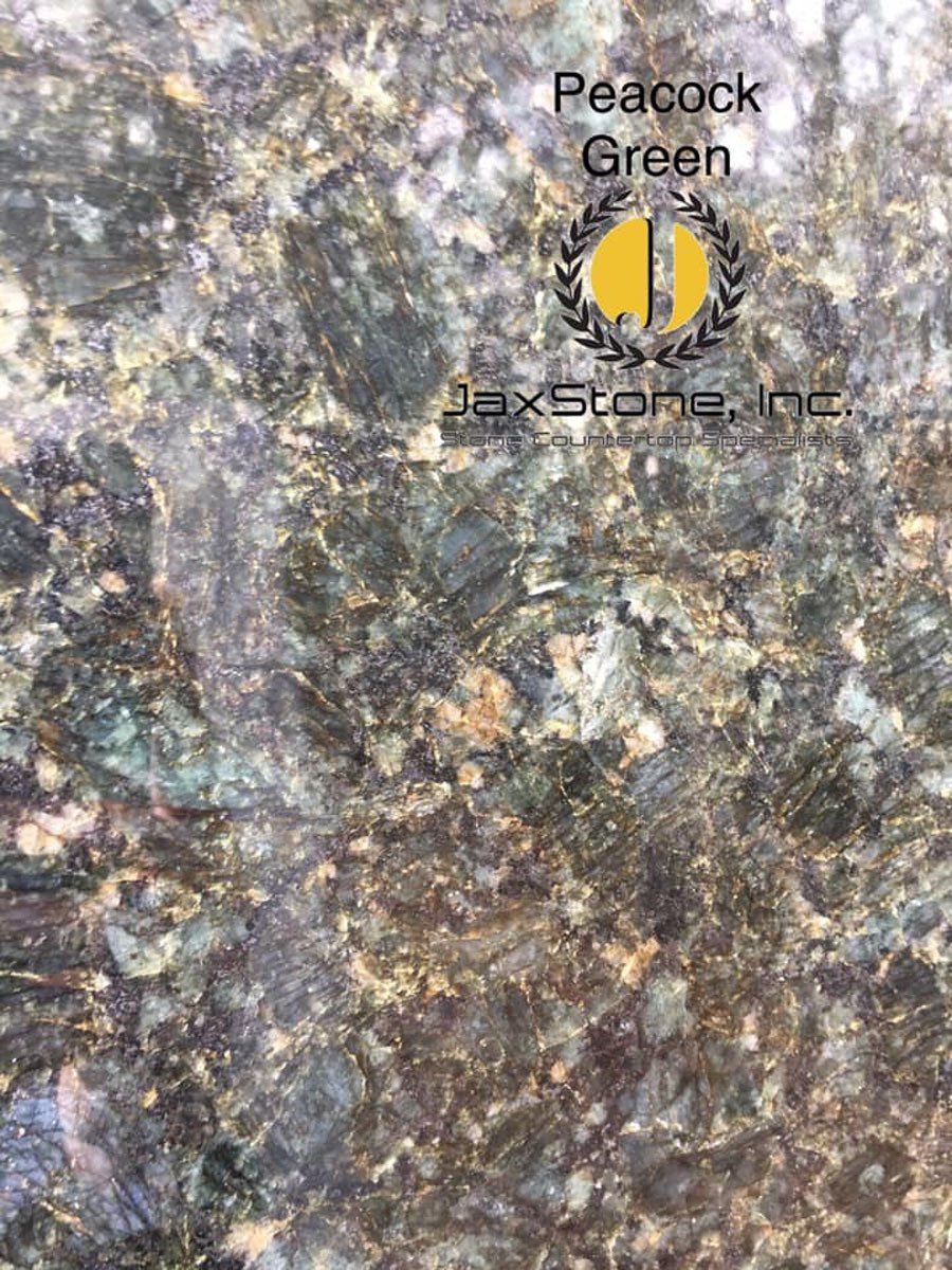A close up of a peacock green granite slab.