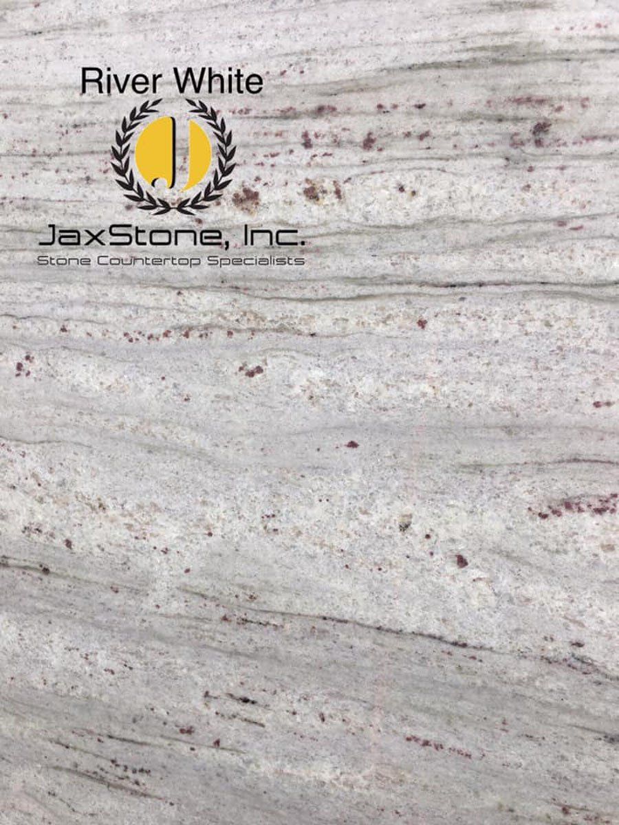 A close up of a white granite counter top with a logo on it.