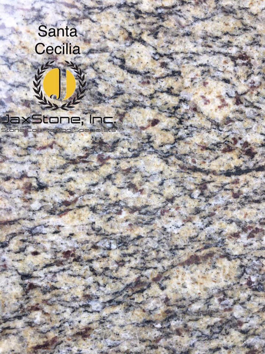 A close up of a granite counter top with the words santa cecilia on it.